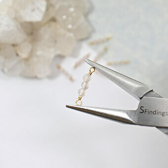 Triple Light Rose Quartz Wrapped In 10kt Solid Gold Wire Hold By A Pair of Precision Pliers