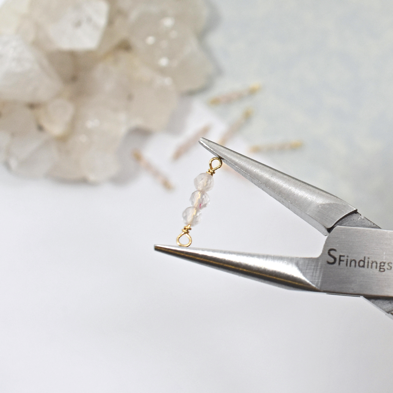 Triple Light Rose Quartz Wrapped In 10kt Solid Gold Wire Hold By A Pair of Precision Pliers