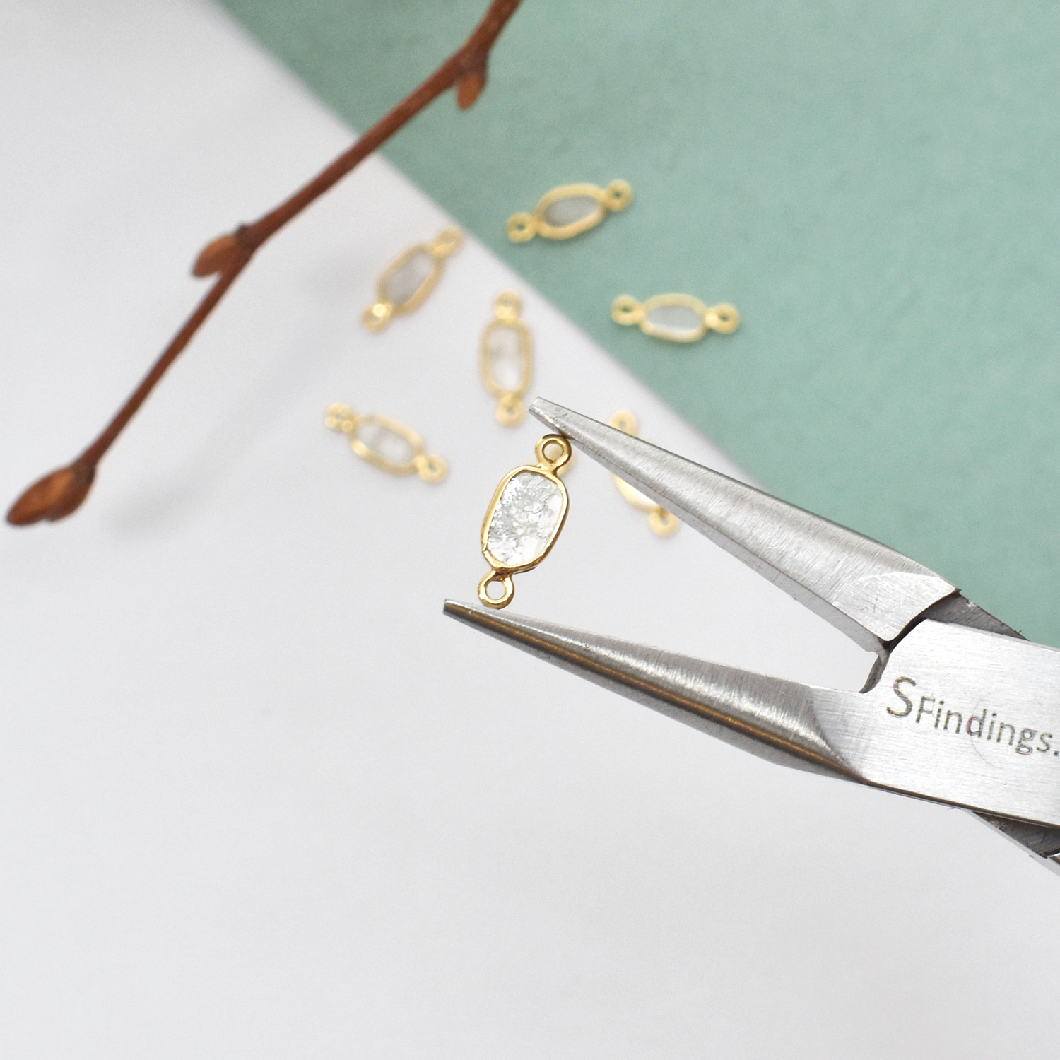 Medium Oval Natural Grey Diamond Slices Bezel in Solid 14kt Gold Connector Hold By A Pair of Precision Pliers